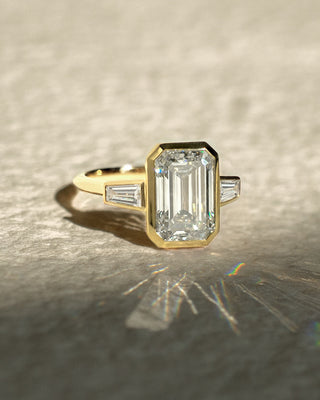 Emerald cut lab grown diamond bezel engagement ring in white gold setting