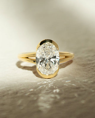 Oval cut lab grown diamond half bezel engagement ring in white gold