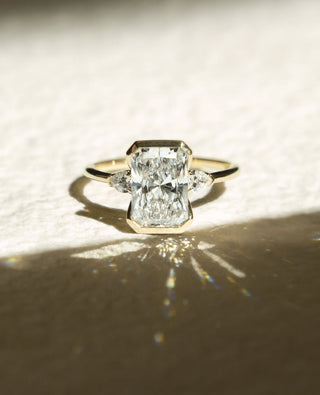 Radiant cut lab grown diamond half bezel engagement ring in white gold setting
