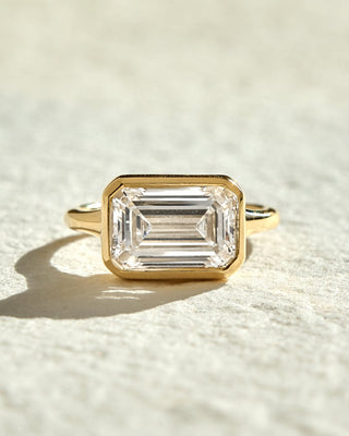 Elongated emerald cut lab grown diamond bezel solitaire engagement ring in white gold