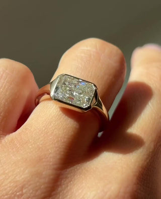 Radiant cut lab grown diamond bezel engagement ring in white gold setting