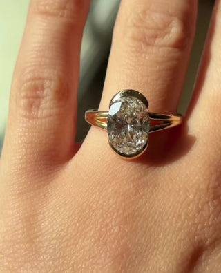 Oval cut lab grown diamond half bezel engagement ring in white gold
