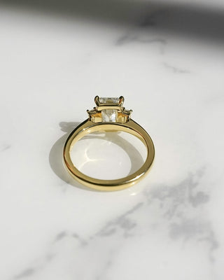 Emerald cut lab grown diamond three stone engagement ring in white gold setting