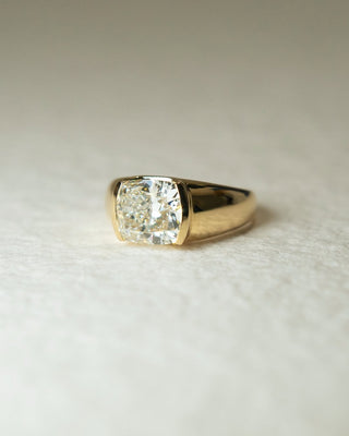 Cushion cut lab grown diamond bezel engagement ring with sleek design