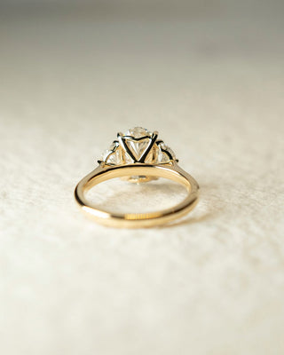 Oval cut lab grown diamond three stone engagement ring with classic band