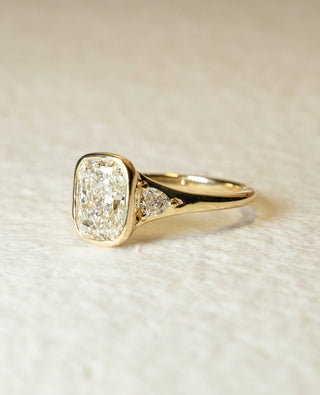 Cushion cut lab grown diamond bezel engagement ring with sleek white gold band