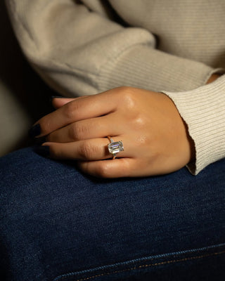 Emerald cut lab grown diamond three stone engagement ring with sleek band