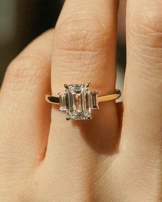 Emerald cut lab grown diamond three stone engagement ring in white gold setting