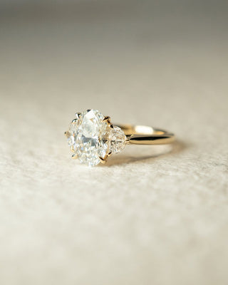 Oval cut lab grown diamond three stone engagement ring with classic band