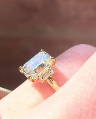 Emerald cut lab grown diamond three stone engagement ring in white gold setting
